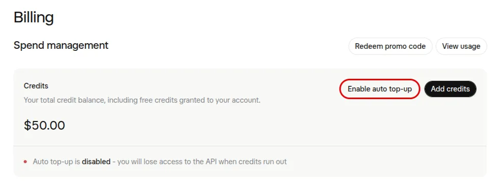 xAI’s Billing page: Spend management with Redeem promo code and View usage, Credits of $50.00 with the Enable auto top-up button outlined in red beside Add credits, and a line saying Auto top-up is disabled, you will lose access to the API when credits run out